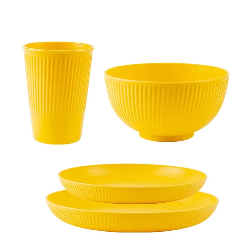 4-piece yellow wheat straw tableware set with plate, bowl, and cup, eco-friendly unbreakable dinnerware for kitchen and camping.