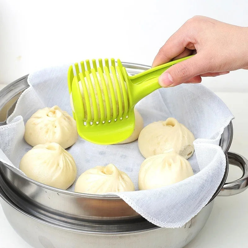 Stainless steel handheld slicer for oranges, lemons, and tomatoes in use.