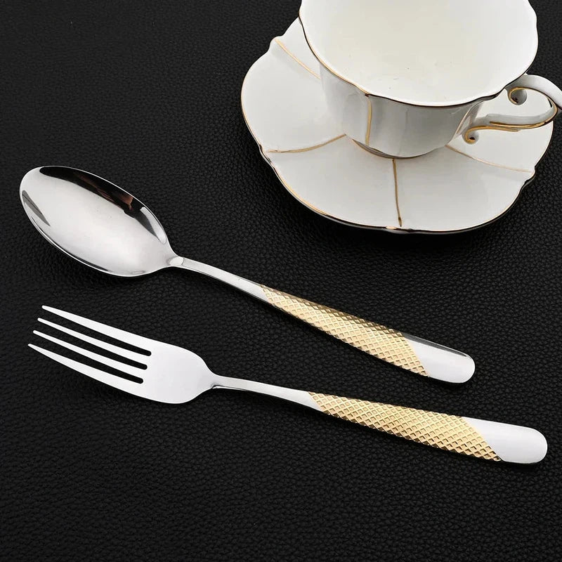 24-piece stainless steel tableware set with mirror finish knives, forks, and spoons, shown with a teacup.