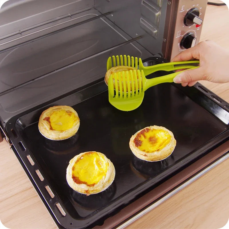 Handheld kitchen slicer with aluminum alloy blades used for cutting fruits like oranges and lemons.