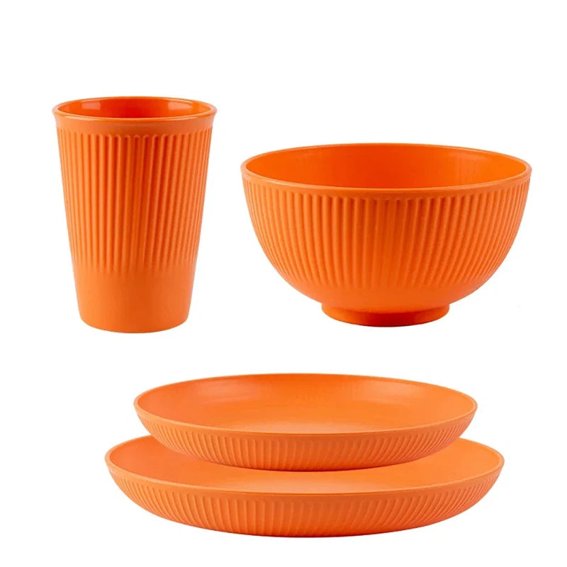 4-piece wheat straw tableware set including plate, dish, bowl, and cup in orange; eco-friendly and unbreakable dinnerware for camping.