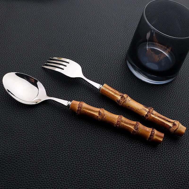 6/24Pcs bamboo handle stainless steel dinnerware set with fork and spoon on black background