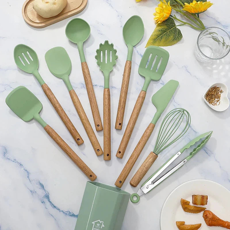 11-piece silicone cooking utensils set with wooden handles, eco-friendly kitchen tool set on marble countertop.