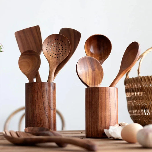 Wooden kitchen utensils set with soup spoon, spatula, and rice spoon in a stylish holder, eco-friendly non-stick cookware.