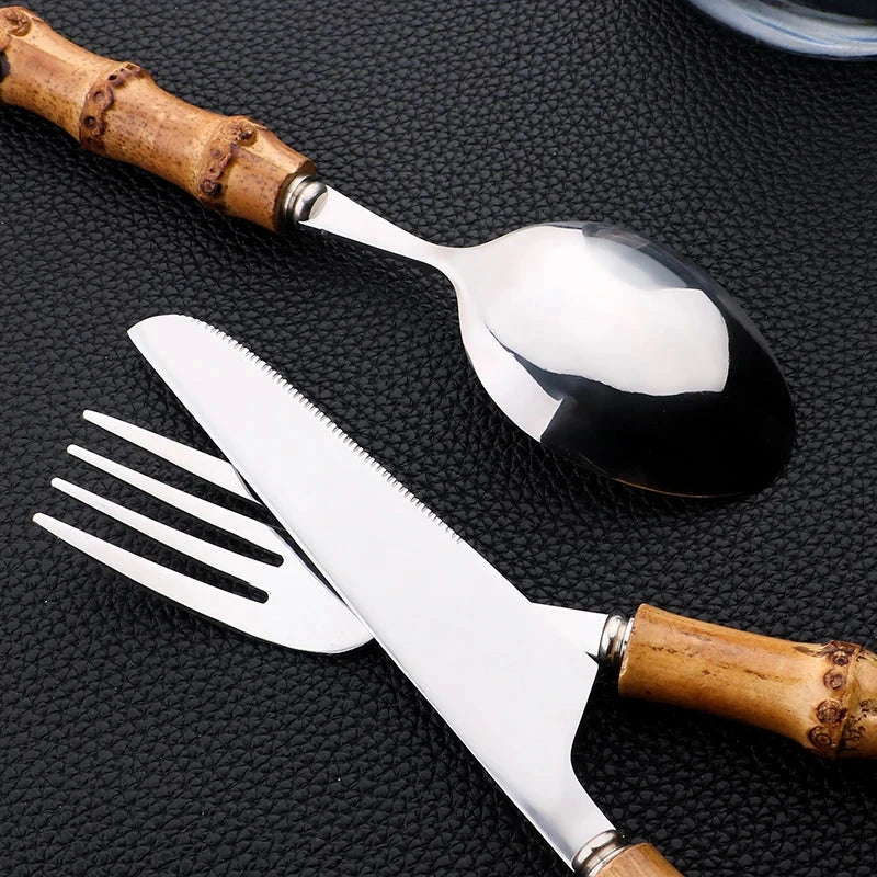 Luxury bamboo handle stainless steel cutlery set with knife, fork, spoon, and rack for 6, eco-friendly dinnerware collection.