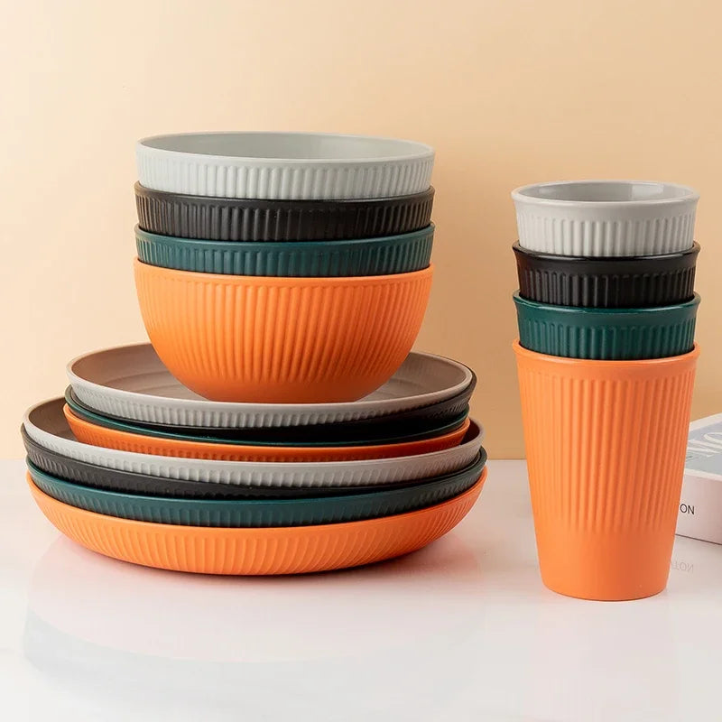 4-piece wheat straw tableware set with plates, bowls, and cups in eco-friendly, unbreakable design for camping and kitchen use.